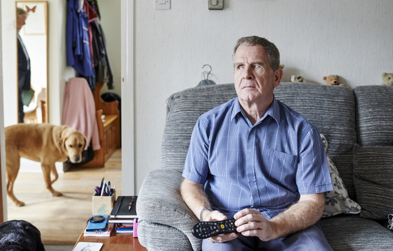 MIke at home sitting in an armchair