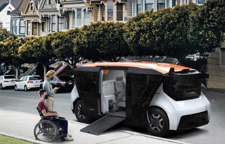 A picture of a wheelchair user waiting to board an automous vehicle. There is a ramp coming out of the vehicle and an non-disabled person in the picture