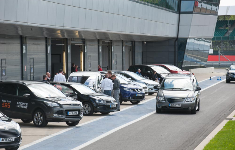 Cars parked next to a test track